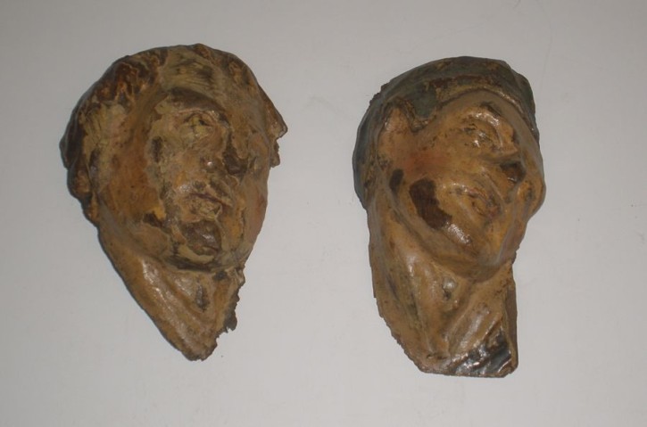 Pair of grotesque heads